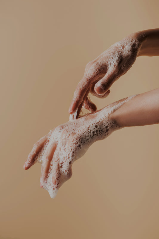 Partial view of female hands in soap foam